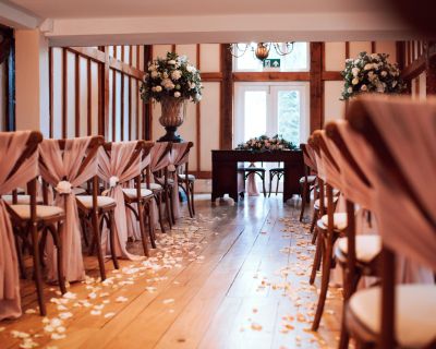 Preparing the aisle for a barn wedding ceremony | Vaulty Manor | Essex